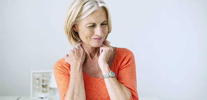 Mature woman suffering from neck and shoulder pain before visiting Concord chiropractor