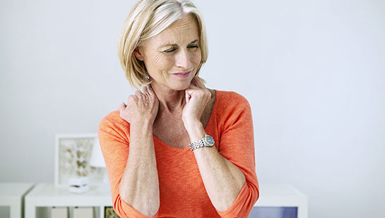 Mature woman suffering from neck and shoulder pain before visiting Concord chiropractor