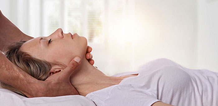 Woman receiving neck adjustment from Concord chiropractor