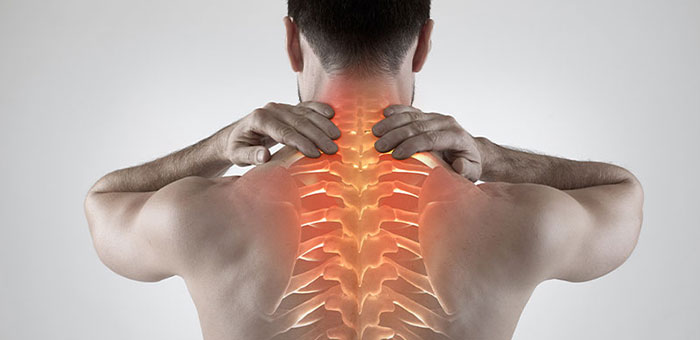 Man with upper back pain before chiropractic treatment from Concord chiropractor